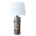 Table lamp made from a Combustion liner from an aircraft engine. White linen shade