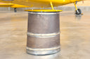 Accent table made from tailpipe assembly of a convair aircraft. oval glass top. Burnished bronze patina with polished steel rings. 19.5" high