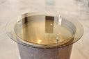 round bronze glass top on Accent table made from tailpipe assembly of a convair aircraft. Burnished bronze patina with polished steel rings. 25.5" high