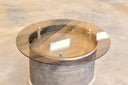 bronze glass top on Accent table made from tailpipe assembly of a convair aircraft. Burnished bronze patina with polished steel rings. 19.5" high