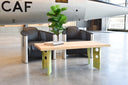 Rectangular coffee table with clear stained ash tops and green aluminum legs made from floor beams from an aircraft.  Staged in front of a CF104 aircraft